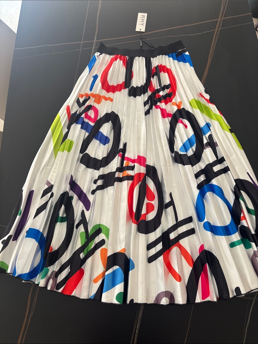 Graphic Pleated Midi Skirt in White with Multicolor Print. Elastic waistband